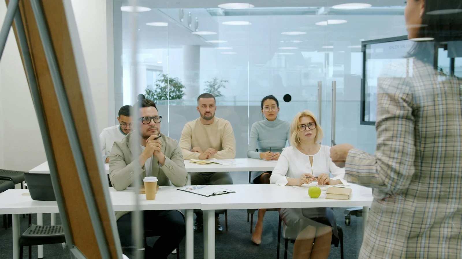 Colleagues listening to a live presenter and reviewing business data together